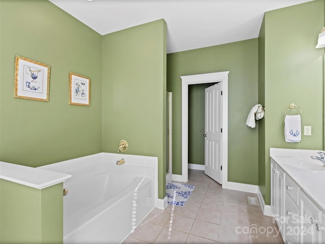 bathroom with a tub to relax in, tile patterned flooring, and vanity