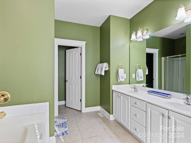 bathroom with a bath, tile patterned flooring, and vanity