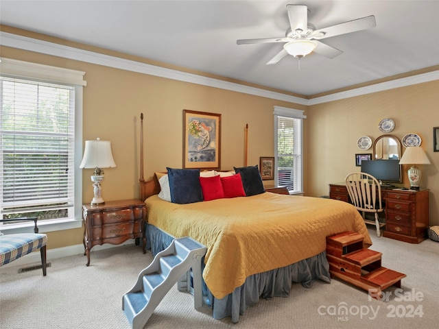 bedroom with ornamental molding, ceiling fan, and carpet floors