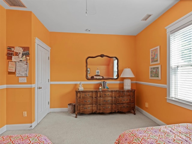 bedroom featuring light colored carpet