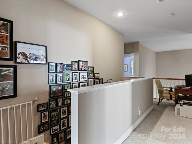 hallway with light colored carpet