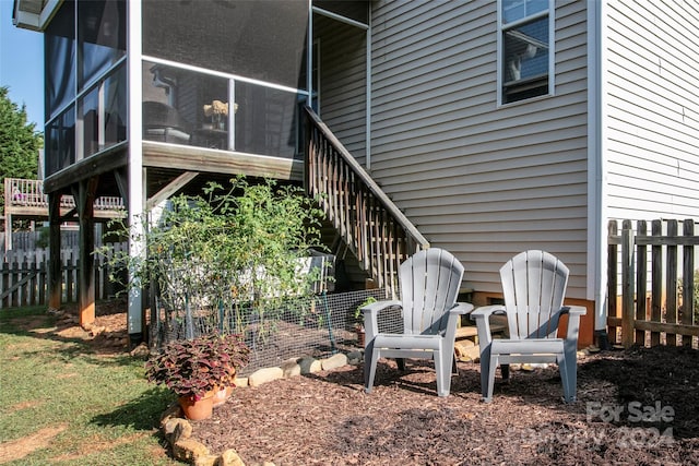 view of side of property featuring a sunroom