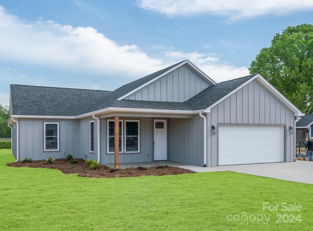 view of front of house featuring a garage and a front lawn