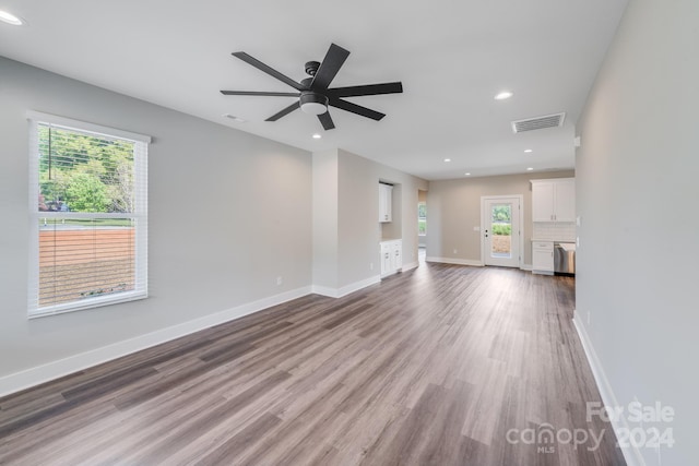 unfurnished living room featuring hardwood / wood-style flooring and ceiling fan