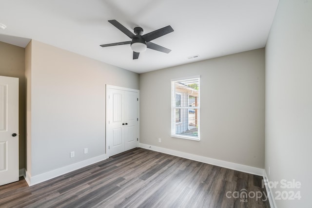 interior space with dark wood-type flooring and ceiling fan