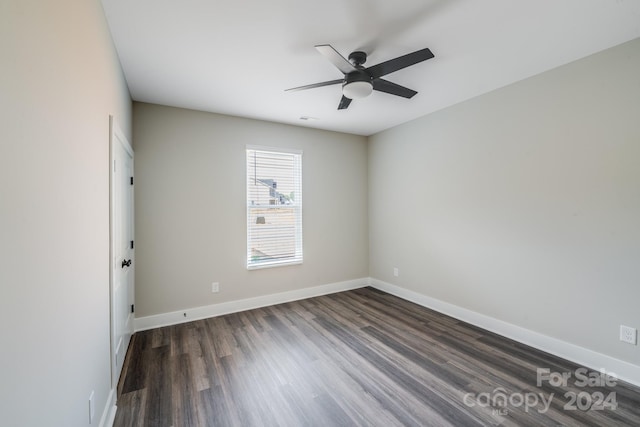 spare room with dark wood-type flooring and ceiling fan