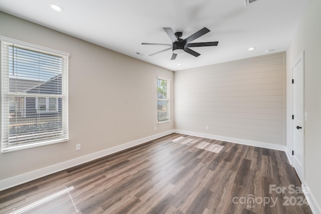 spare room with ceiling fan and dark hardwood / wood-style floors