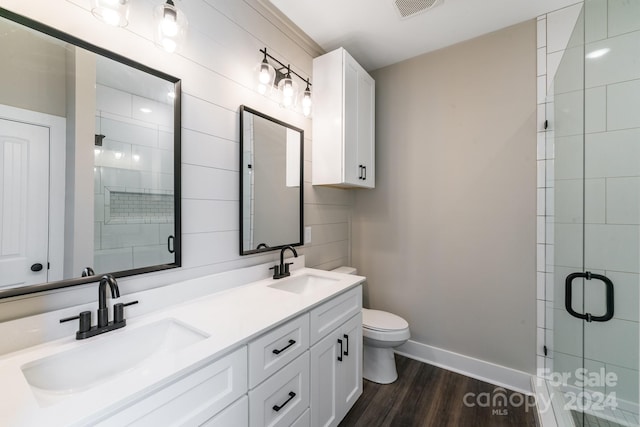 bathroom with toilet, an enclosed shower, wood-type flooring, and vanity