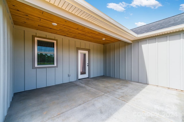 view of exterior entry with a patio area