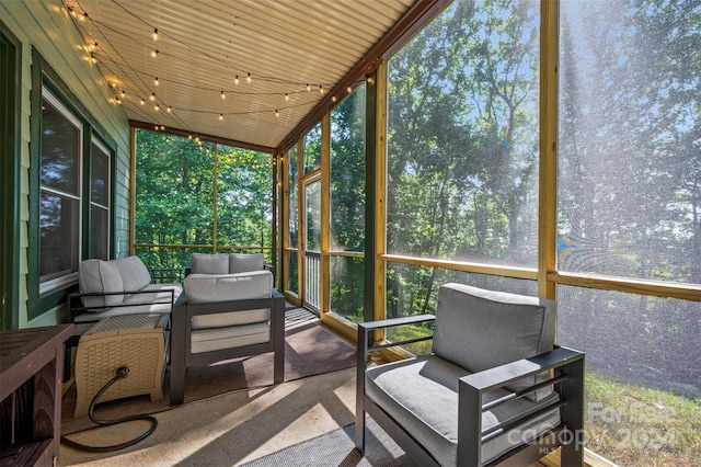 sunroom / solarium featuring plenty of natural light and wooden ceiling