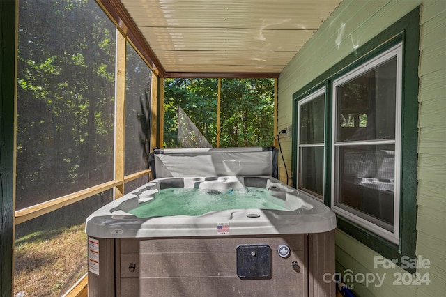 sunroom / solarium featuring a hot tub and wooden ceiling