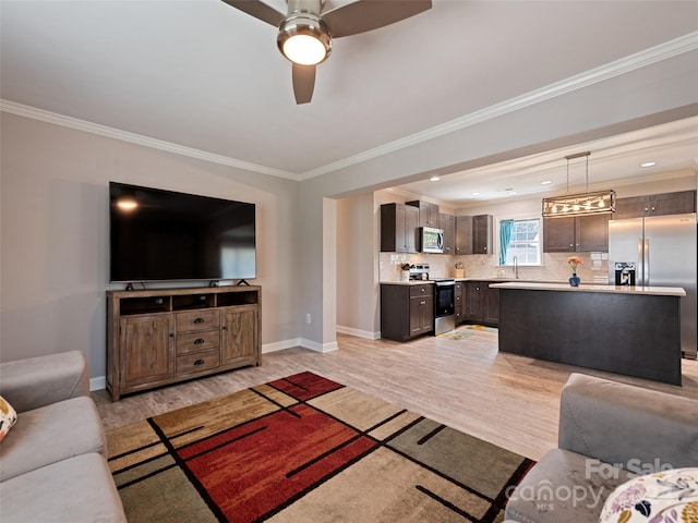 living room with light wood-type flooring, ornamental molding, and ceiling fan