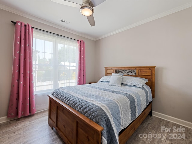 bedroom with ornamental molding, wood-type flooring, and ceiling fan