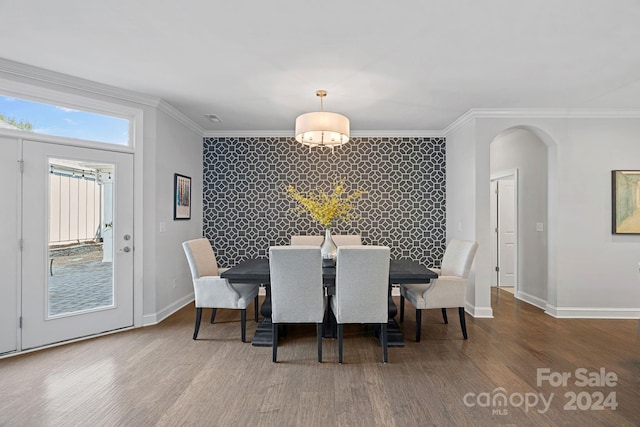 dining room featuring crown molding and hardwood / wood-style floors