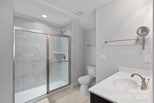 bathroom with vanity, toilet, tile patterned flooring, and a shower with door