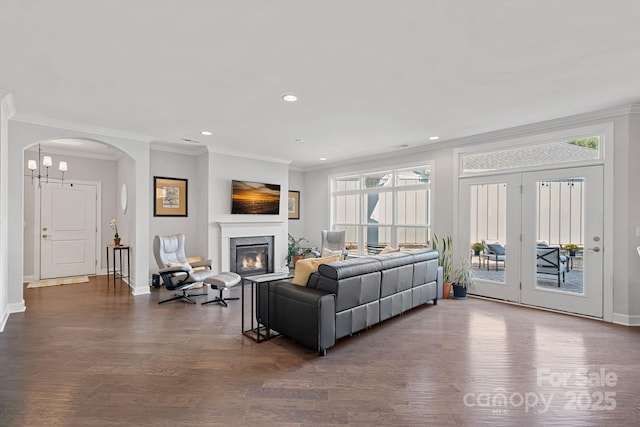 living room with ornamental molding and dark hardwood / wood-style floors