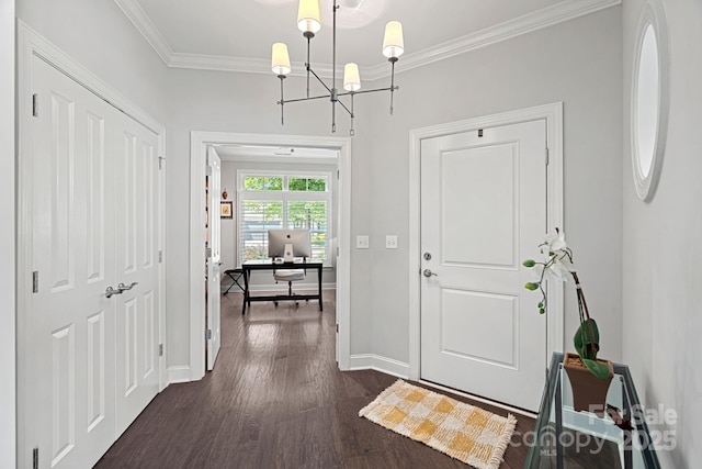 foyer entrance with ornamental molding, dark hardwood / wood-style flooring, and a chandelier