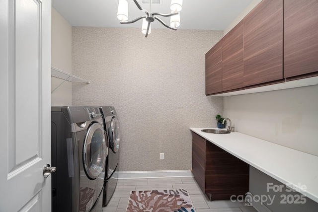 washroom featuring cabinets, independent washer and dryer, a chandelier, and sink