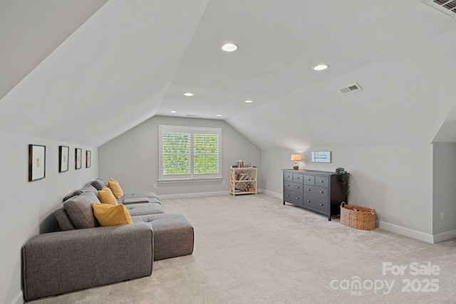 sitting room with vaulted ceiling and light carpet