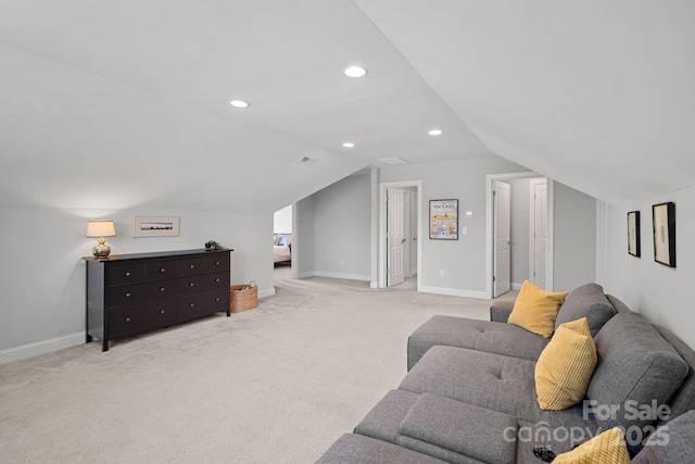 carpeted living room with vaulted ceiling