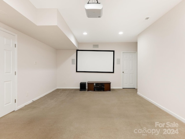 cinema room with light colored carpet