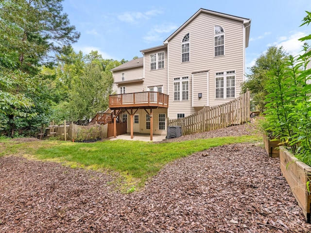 rear view of property with a deck and a patio