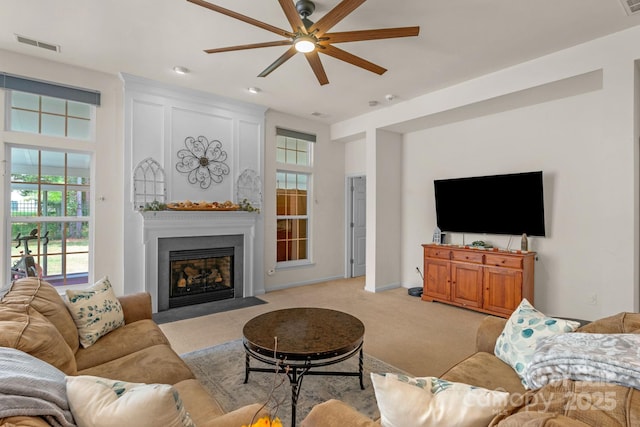 carpeted living room featuring ceiling fan