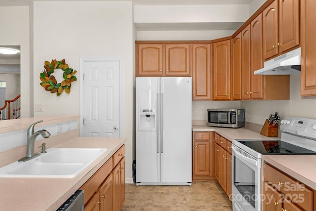 kitchen featuring sink and white appliances