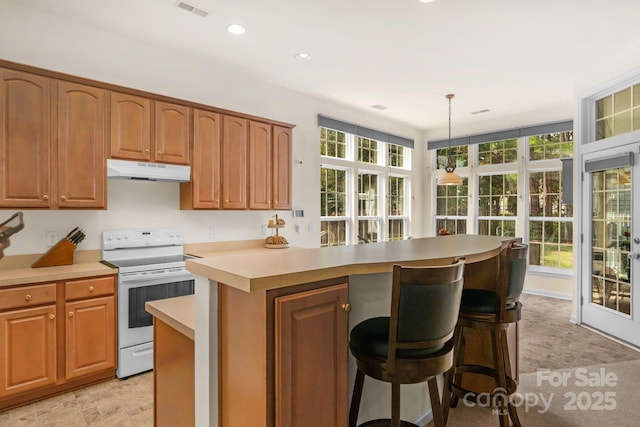 kitchen with a center island, an inviting chandelier, a kitchen breakfast bar, white electric stove, and decorative light fixtures