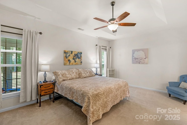 bedroom with ceiling fan and light carpet