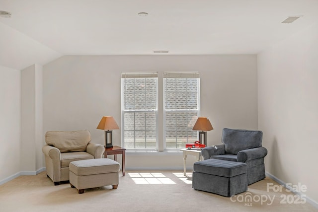 living area with light colored carpet and lofted ceiling