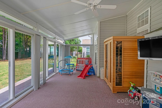 sunroom featuring ceiling fan, a healthy amount of sunlight, and lofted ceiling