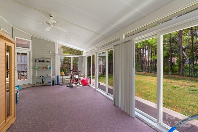 unfurnished sunroom with ceiling fan and lofted ceiling