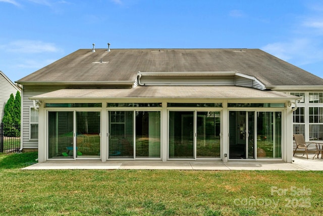 rear view of property with a yard and a patio