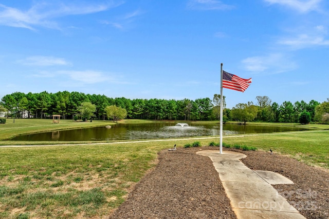 view of community with a lawn and a water view