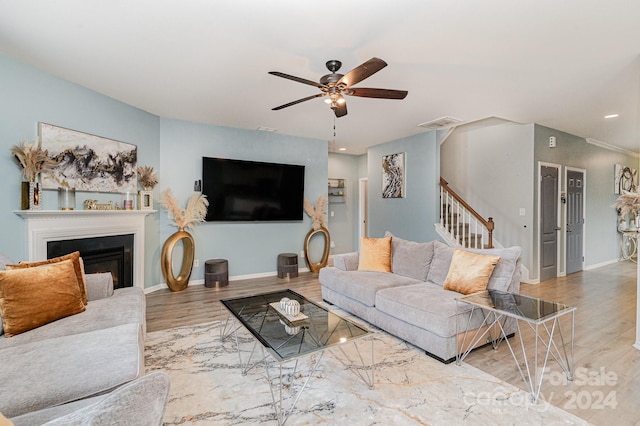 living room featuring ceiling fan and light wood-type flooring