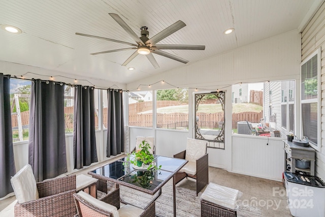 sunroom / solarium featuring ceiling fan and lofted ceiling