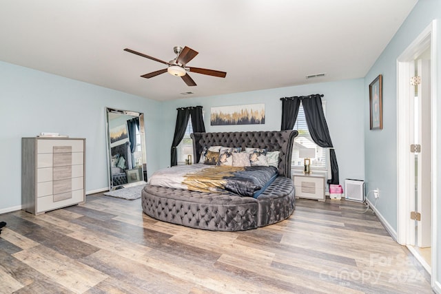 bedroom with ceiling fan and hardwood / wood-style floors