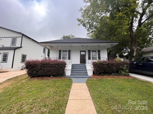 bungalow-style home with a front yard and a porch