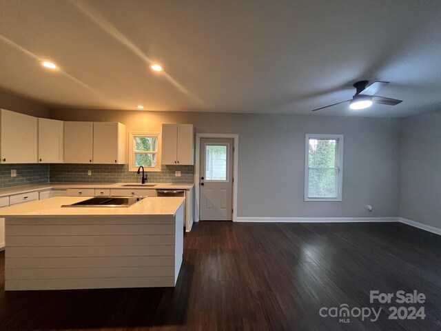 kitchen featuring a healthy amount of sunlight, ceiling fan, dark hardwood / wood-style floors, and white cabinets