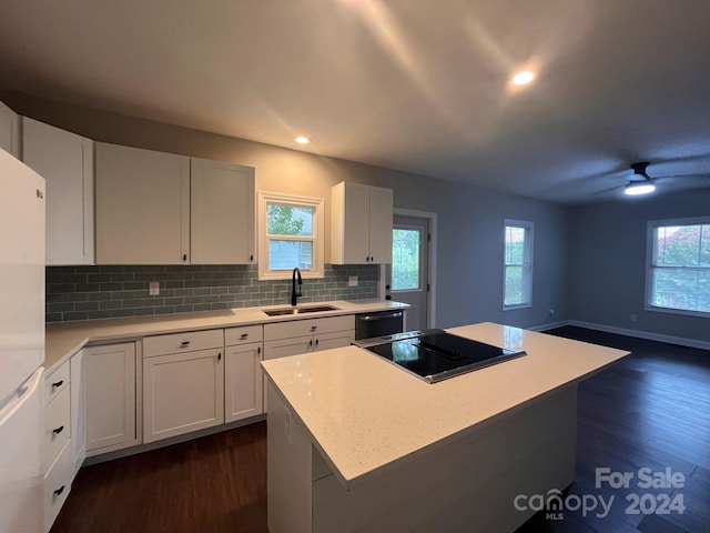 kitchen featuring white cabinets, ceiling fan, dark hardwood / wood-style flooring, and sink