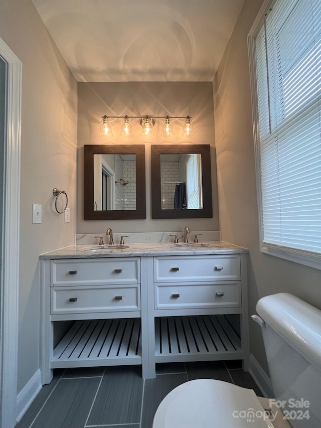 bathroom with vanity, toilet, and tile patterned flooring