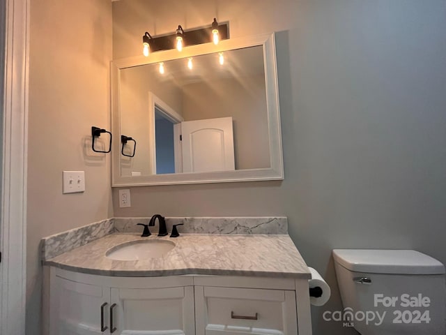 bathroom featuring toilet and vanity