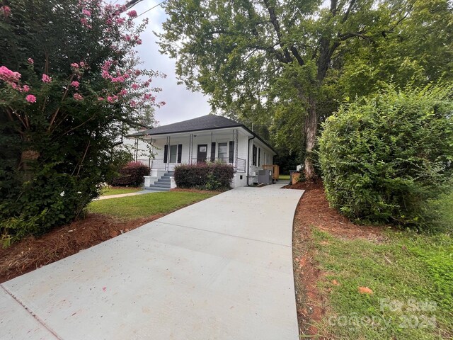 view of front facade with central AC and a porch