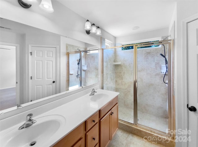 bathroom with vanity, walk in shower, and a healthy amount of sunlight