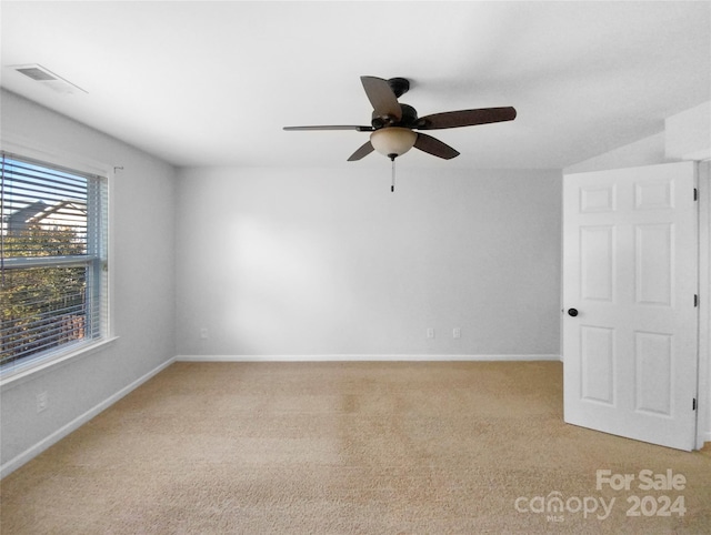 carpeted spare room with ceiling fan