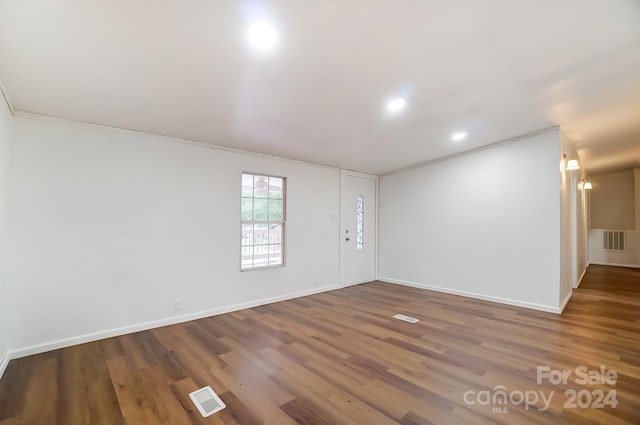 unfurnished room with wood-type flooring