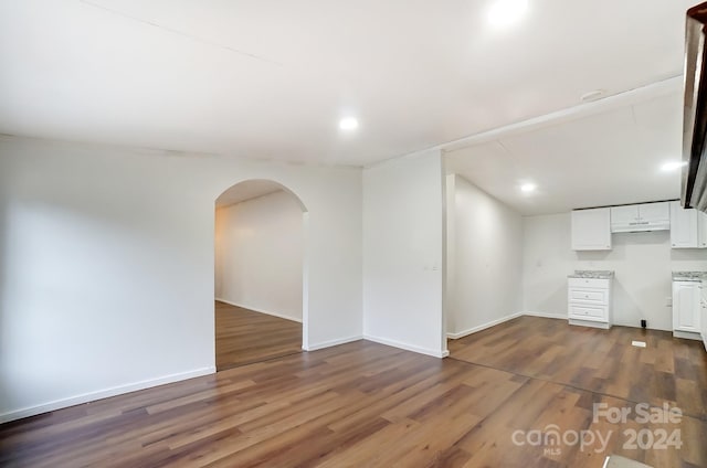 spare room with dark wood-type flooring