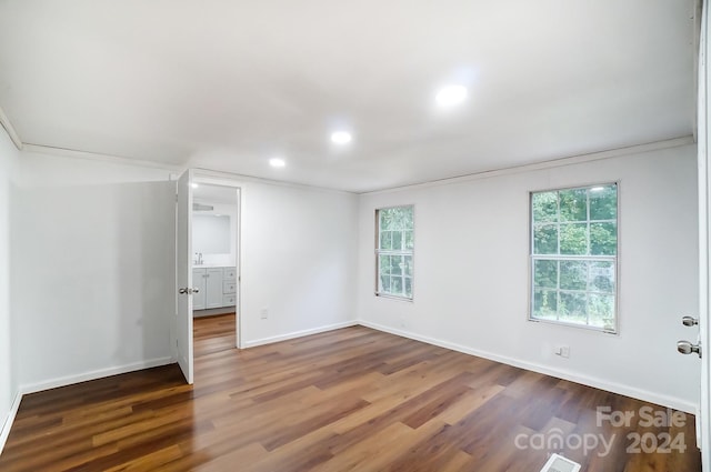 unfurnished room with hardwood / wood-style flooring