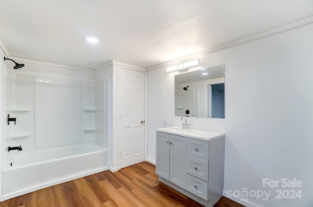 bathroom with wood-type flooring, shower / bath combination, and vanity